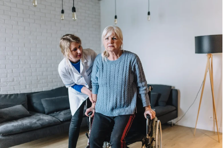 Caregiver helping a senior woman with mobility support at Elite Care Assisted Living Facility in Lakeland, Florida, focusing on personal hygiene and comfort.