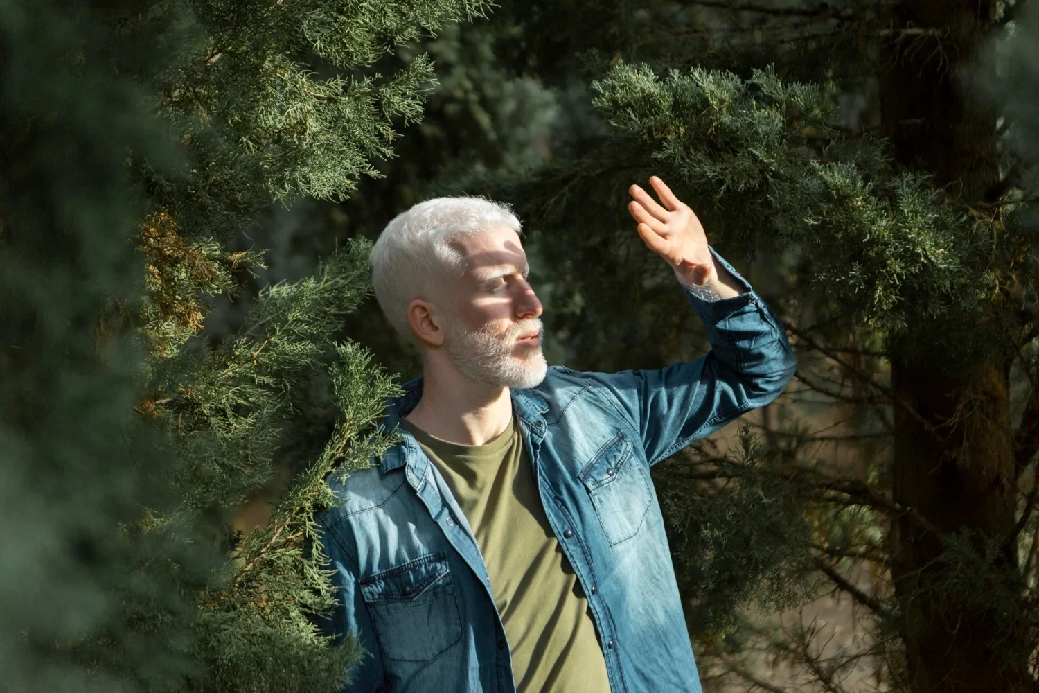 Senior man walking outdoors, surrounded by trees, with a focus on security and peace of mind.