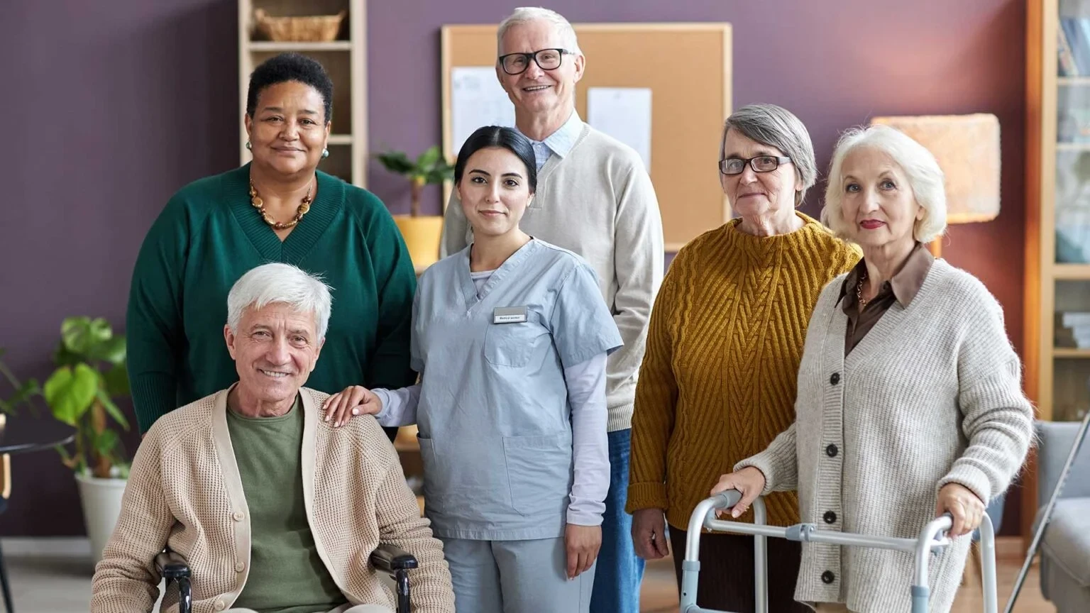 Residents and staff smiling together, showing a vibrant and welcoming community at an assisted living facility.